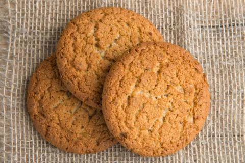 Stack of freshly baked oat biscuits on the background of burlap Stock Photos