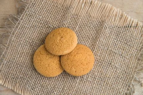 Stack of freshly baked oat biscuits on the background of burlap Stock Photos