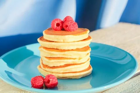 A stack of freshly baked pancakes decorated with raspberries Fotos de archivo