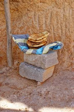 Stack of Freshly Baked Traditional Tunisian Tabouna Flatbread Resting on St.. Stock Photos