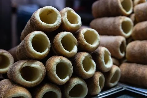 Stack of freshly baked trdelnik close-up, traditional Prague dessert Stock Photos