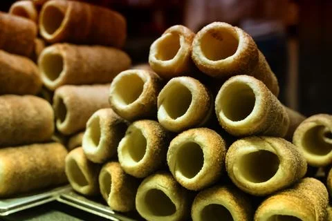 Stack of freshly baked trdelnik close up, traditional european dessert sele.. Stock Photos