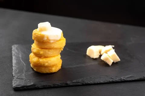 A Stack of Fried Polenta Discs, copy space for your text on the dark background Stock Photos