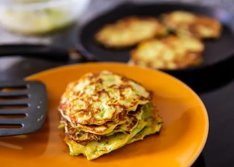 Stack of frying zucchini pancakes in kitchen at home 스톡 사진