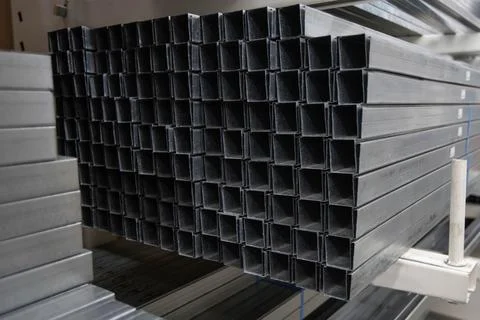 Stack of galvanized rectangular steel pipes for building materials. Production Stock Photos