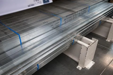 Stack of galvanized rectangular steel pipes for building materials. Production Stock Photos