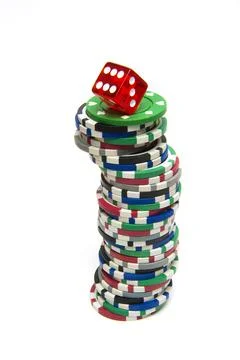 Stack of gambling chips with dice on top isolated on a white background Stock Photos