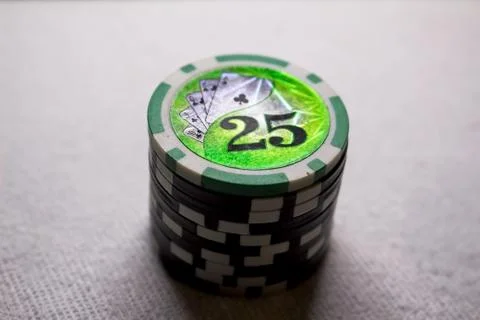 A stack of game chips with a par value of twenty-five, against a dark background Stock Photos