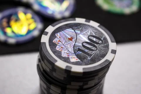 A stack of game chips with a rating of SRT on a dark background Stock Photos