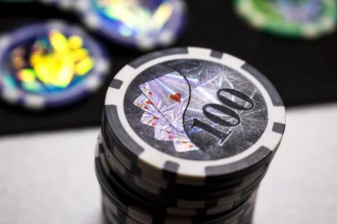 A stack of game chips with a rating of SRT on a dark background. Stock Photos