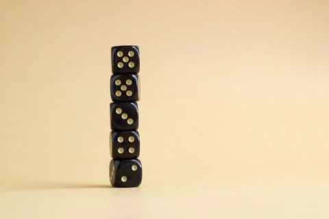 Stack of gaming dice with copy space on beige background. Concept for games,  Stock Photos