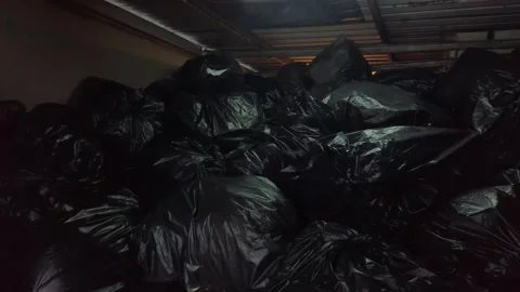 Stack Of Garbage Bags Piled Indoor - Old Shed Backyard - Panning Shot 動画素材 144949177
