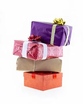 Stack of gift box in festive paper with a bow on an isolated background, a .. Stockfoto's