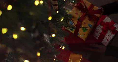 Stack of gift boxes with a red bow place under new year tree with christmas Stock Footage 221477610