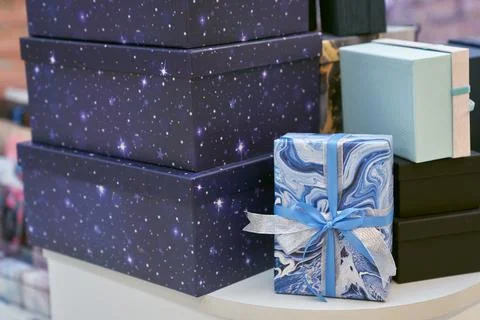 A stack of gift boxes, on a shelf in the store. It symbolizes the joy and Stock-Fotos