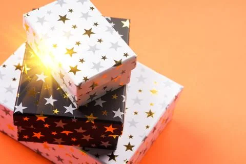 Stack of gift boxes with stars. Magic light Stock Photos