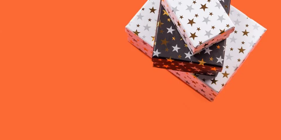 Stack of gift boxes with stars on orange Stock Photos
