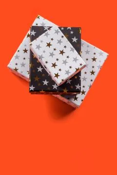 Stack of gift boxes with stars on orange Stock Photos