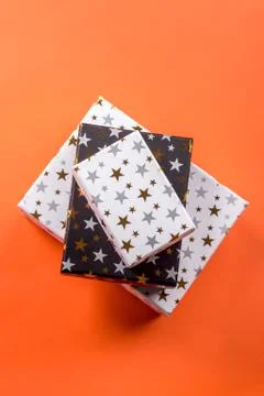 Stack of gift boxes with stars on orange Stock Photos