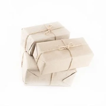 Stack of giftbox in plain brown paper tied with twine on isolated background Foto stock
