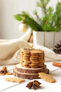 Stack of ginger cookies and spices on wooden tabletop Stock Photos