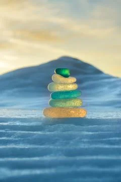 Stack of glass pebble on sunset Stock Photos