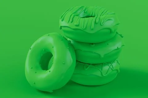 Stack of glazed donut with sprinkles on plain monochrome green color Stock Photos