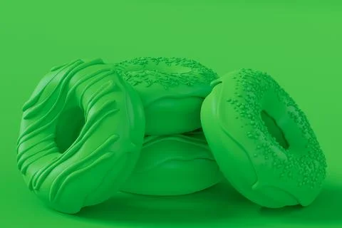 Stack of glazed donut with sprinkles on plain monochrome green color Stock Photos