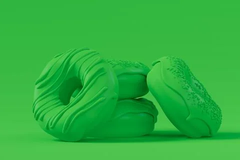 Stack of glazed donut with sprinkles on plain monochrome green color Foto stock