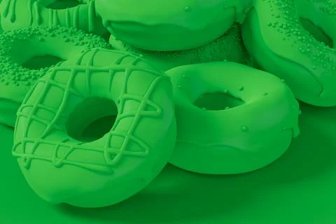 Stack of glazed donut with sprinkles on plain monochrome green color Stock Photos