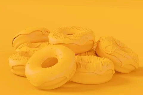 Stack of glazed donut with sprinkles on plain monochrome yellow color Foto stock