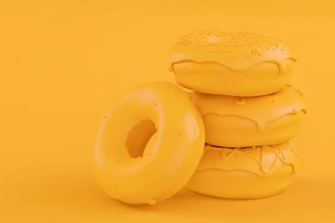 Stack of glazed donut with sprinkles on plain monochrome yellow color Stock Photos