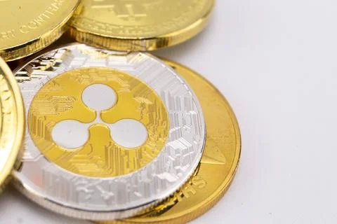 Stack of Gold and Silver Cryptocurrency Coins Featuring Ripple Logo on a Wh.. Stock Photos