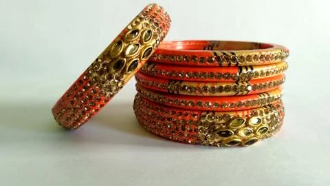 Stack of gold bangle with vivid color and rhinestone isolated on white backgr Stock Photos