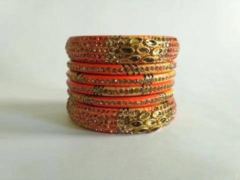 Stack of gold bangle with vivid color and rhinestone isolated on white backgr Stock Photos