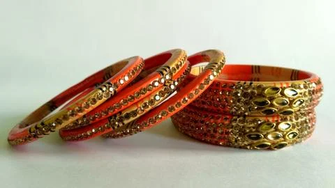 Stack of gold bangle with vivid color and rhinestone isolated on white backgr Stock Photos