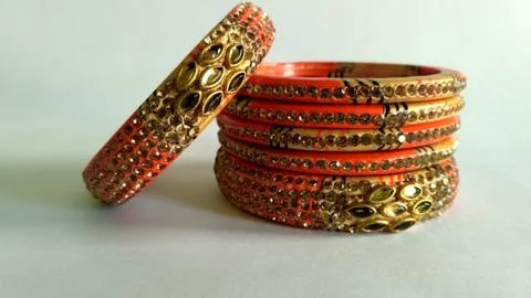 Stack of gold bangle with vivid color and rhinestone isolated on white backgr Stock Photos