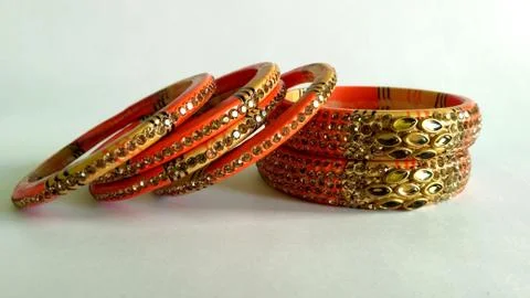 Stack of gold bangle with vivid color and rhinestone isolated on white backgr Stock Photos