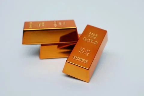 Stack of gold bars shining on a white background Stock Photos