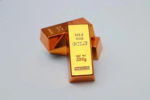 Stack of gold bars shining on a white background Stock Photos