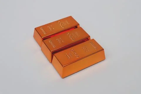 Stack of gold bars shining on a white background Stock Photos