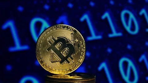 A stack of gold coins. gold bitcoin in the background of a binary code. Digital Stock Footage 271352905