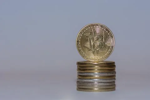 Stack of gold valueable bitcoins crypto currency with gray background front Stock Photos