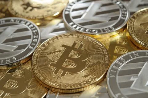 Stack of golden bitcoin and silver litecoin coins Stock Photos