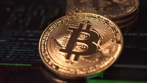 Stack of golden bitcoins with a green code programming background Stock Footage 124609958
