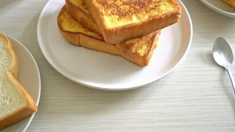 Stack of golden brown toasts with butter on top Stock Photos