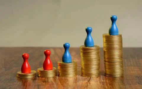 Stack of Golden Coins Graph going up with pawns Stock Photos