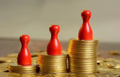 Stack of Golden Coins Graph going up with pawns Stock Photos