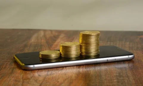 Stack of Golden Coins on Mobile Screen - Earning concept Foto stock
