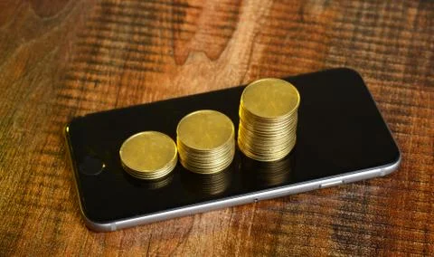 Stack of Golden Coins on Mobile Screen - Earning concept Stock Photos